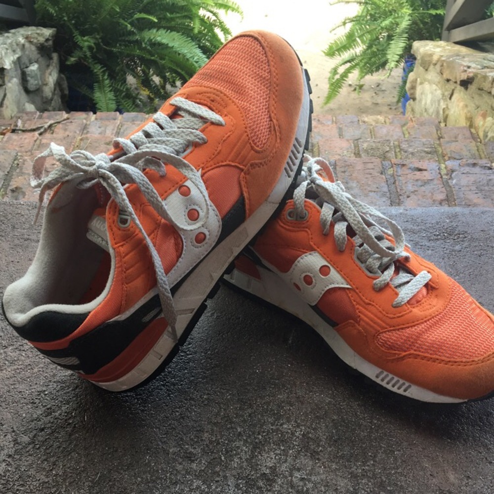 Orange Saucony tennis shoes